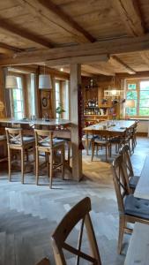 a dining room with wooden tables and chairs at Huus74 in Menziken