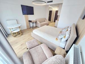 a living room with a large bed and a couch at Hanza Tower AJP Jaccuzi SPA apartament in Szczecin