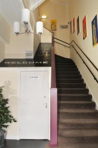 a staircase in a building with a pink door at The Hostel in Edinburgh