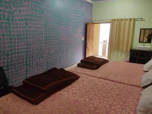 a bedroom with two beds with towels on them at Hotel Sandeep palace in Jāmb