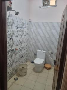a bathroom with a toilet and a shower at Hotel Sandeep palace in Jāmb