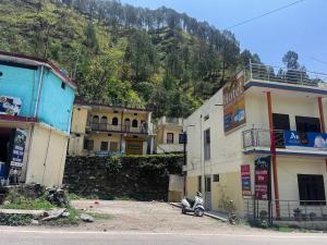 a group of buildings with a scooter parked in front at Hotel Sandeep palace in Jāmb