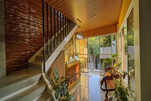 a house with a staircase and a balcony with plants at Manuela Suites Puerto Princesa near Airport in Puerto Princesa City