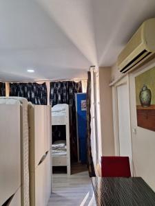 a small room with a refrigerator and a bedroom at Paxx Istanbul Hotel&Hostel in Istanbul