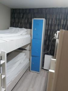 a room with two bunk beds and a blue door at Paxx Istanbul Hotel&Hostel in Istanbul