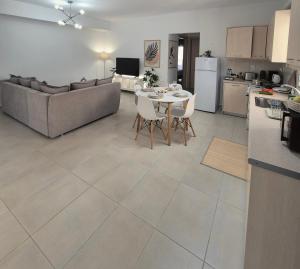 a kitchen and living room with a table and a couch at Idene Penthouse in Chania