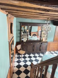 a bedroom with a mirror and a checkered floor at Maison de Beaugency centre boîte à clefs vélos dans la maison in Beaugency