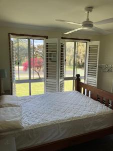 a bedroom with a bed and a large window at Walpole House in Walpole