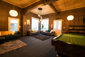 a living room with a pool table in it at Crashpalace Napier in Napier