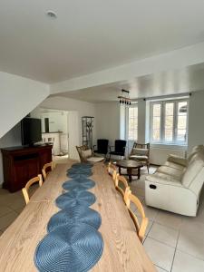 a living room with a couch and chairs and a rug at La Belle des champs - maison avec terrasse in Courseulles-sur-Mer