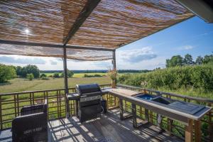 a grill on a deck with a view of a field at Champs des Rêves in Busserolles