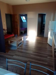 a living room with a table and a couch at Apartmán Nicolass in Šakvice