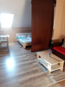 a living room with a bed and a coffee table at Apartmán Nicolass in Šakvice