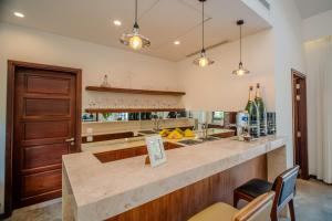 a kitchen with a bar with a counter top at Coco Luxury Villa Mũi Né in Ấp Thiện Phước