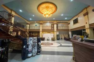 a large lobby with a staircase and a large room with a ball at Garden Suite Hotel near Koreatown in Angeles