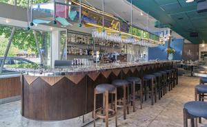 a bar in a restaurant with stools at Scandic Malmen in Stockholm