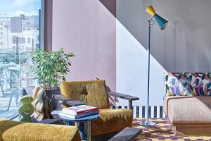 a living room with two chairs and a table at Scandic Malmen in Stockholm