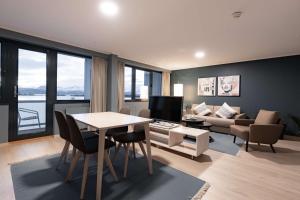 a living room with a table and a couch at Scandic Alexandra Molde in Molde