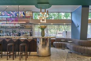 a bar with stools and a counter in a room at Scandic Malmen in Stockholm
