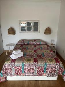 a bedroom with a bed with a quilt on it at Sunset bungalow Oceanfront Relax in Los Realejos +9 photos