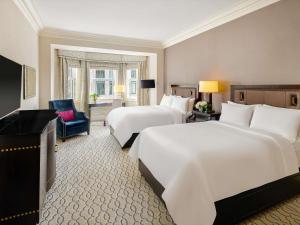 a hotel room with two beds and a chair at Fairmont Chateau Laurier in Ottawa +37 photos