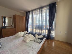 a bedroom with towels on a bed with a window at Sea whisper in Elenite