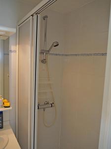a shower with a shower head in a bathroom at APPARTEMENT FACE MER T2 35 m2 pour 4 personnes proche tous commerces in Saint-Jean-de-Monts +27 photos