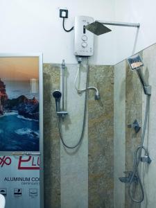 a shower with a shower head in a bathroom at Delight Villa in Tangalle +29 photos