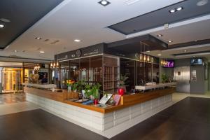a store with a counter with flowers on it at Hotel Dubrovnik in Zenica