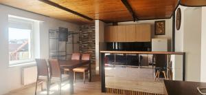a kitchen and dining room with a table and chairs at Prosecco Rynek 14 in Inowrocław
