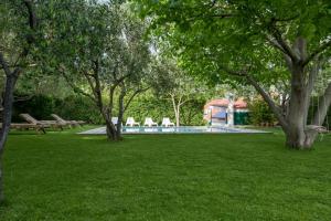 a swimming pool in a park with trees and grass at Quiet Villa near Split, Heated Pool, View, Nature in Klis