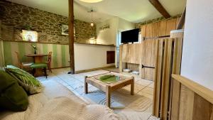 a living room with a table and a tv at Chambres d'Hôtes du Manoir du Haut Salmon in Saint Malo