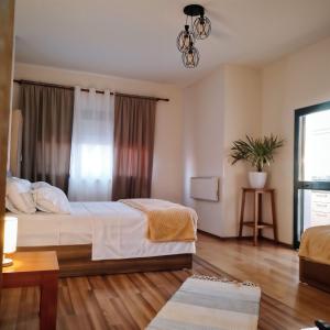 a bedroom with a bed and a window at In the Heart of Shkodra in Shkodër