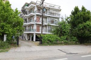 a tall white building with stairs up to it at seasideepanomi in Epanomi