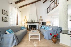 a living room with two couches and a fireplace at Villa Scano in Fort Village