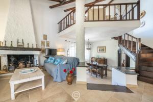 a living room with a couch and a staircase at Villa Scano in Fort Village