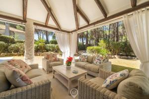 a conservatory with couches and a table at Villa Scano in Fort Village