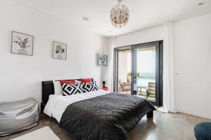 a bedroom with a bed and a view of the ocean at Bica Vista in Lourinhã +53 photos