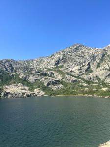 a large lake with a mountain in the background at Résidence Arborea C4 corte in Corte +2 photos