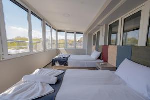 two beds in a room with windows at Diamond Hotel in Istanbul
