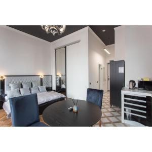 a living room with a bed and a table and chairs at In the heart of the city in Kharkiv