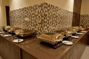 a buffet line with a bunch of food at Rajgriha Luxury Kasauli Stay in Kasauli