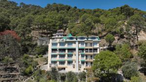 a building on the side of a mountain at Rajgriha Luxury Kasauli Stay in Kasauli