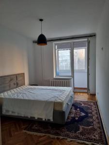a bedroom with a bed and a large window at House of Westeros - OldTown in Chişinău