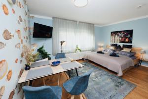 a bedroom with a bed and a table and chairs at Keksfabrik Lofts zentral in Hamburg in Hamburg