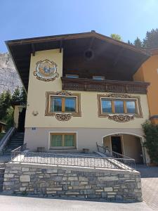 a building with a staircase in front of it at Haus Bernkogel in Dorfgastein