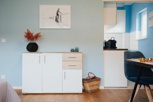 a kitchen with two white cabinets and a table at Keksfabrik Lofts zentral in Hamburg in Hamburg +46 photos