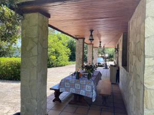 a table with a blue table cloth on a patio at Cabaña de ensueño en el bosque y junto al mar in Miengo +52 photos