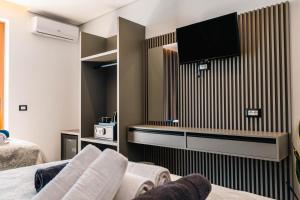 a hotel room with a tv and a bed at Blue Bay Hotel in Sarandë