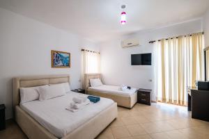 Postel nebo postele na pokoji v ubytování Blue Bay Hotel